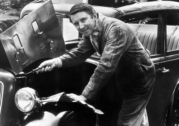 Liberal Party Leader David Steel MP, wearing overalls as he makes repairs to his motor