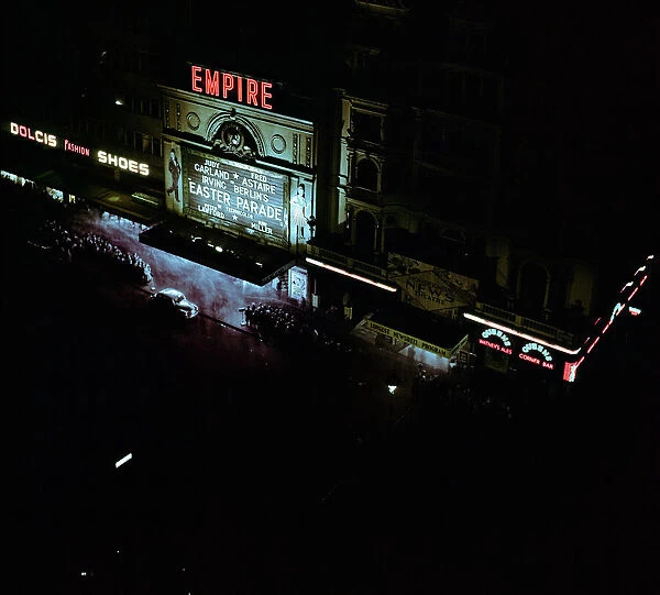 Lights of london. Empire cinema illuminated as crowds queue to watch the film