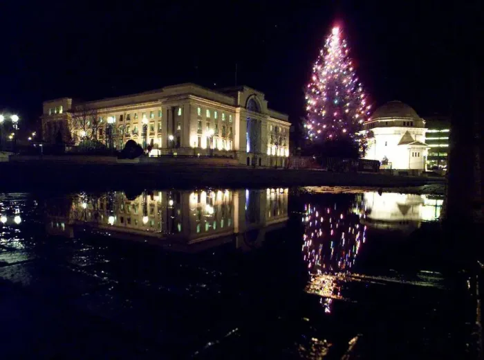 Framed Print : The lights of the newly switched on christmas tree, reflect in a puddle with Baskerville Framed Print : The lights of the newly switched on christmas tree, reflect in a puddle with Baskerville