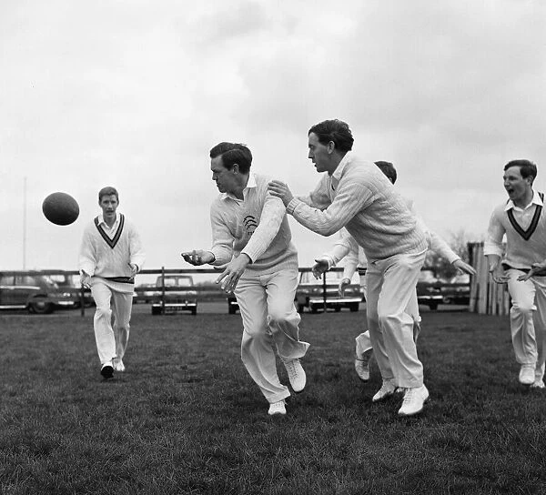Limbering up with a rugby ball are Essex cricket team members Ken Preston (centre