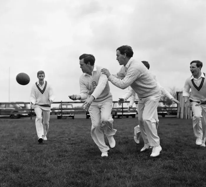 Framed Print : Limbering up with a rugby ball are Essex cricket team members Ken Preston (centre