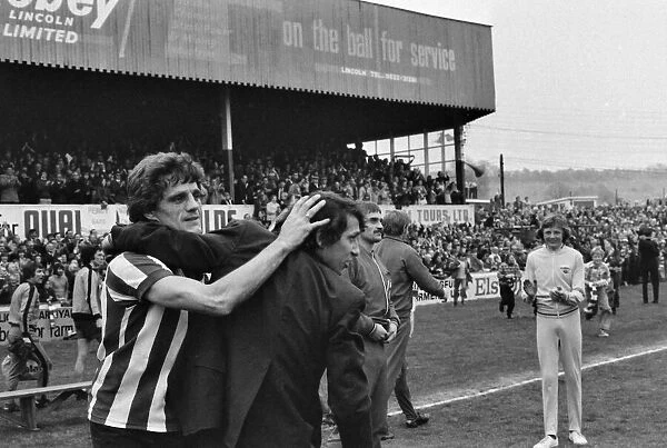 Lincoln manager Graham Taylor and star player Percy Freeman celebrate takes to the pitch