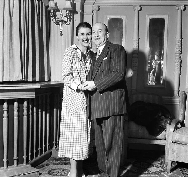 Linda Leigh Fashion Show. Man wearing a pinstripe suit holding hands with a woman