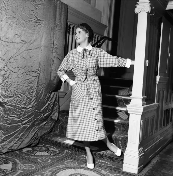 Framed Print : Linda Leigh Fashion Show. Woman poses by the stairs wearing a long check patterned dress