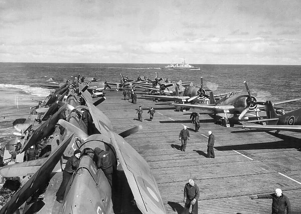 Lined up on each side of the white line on the flight deck of HMS Emperor waiting for