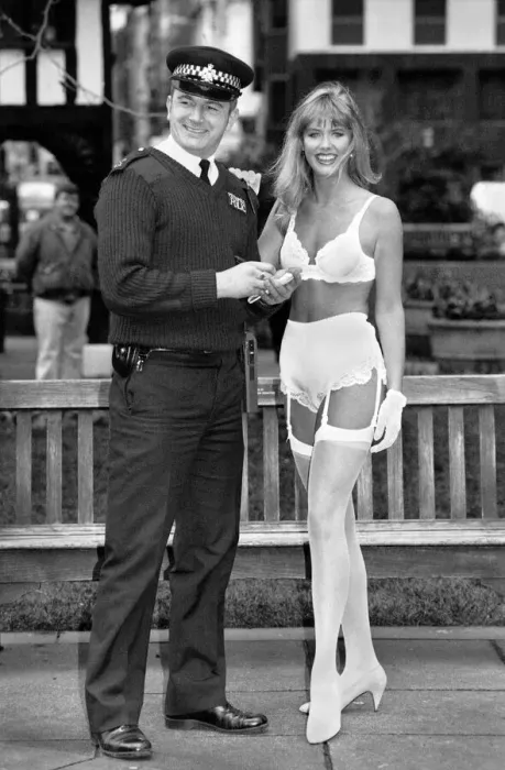 Framed Print : Lingerie that changes colour with your mood. Model in lingerie with policeman