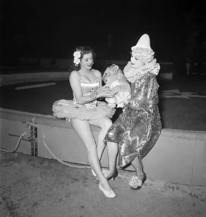 Framed Print : Lion Cub with Performers. Female clown and ballerina. December 1948 O16187-002