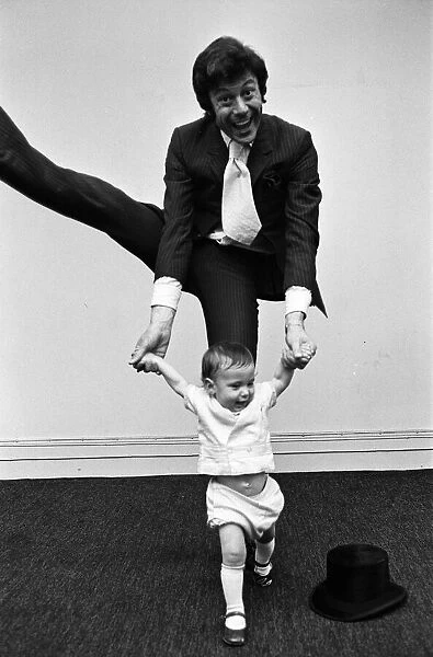 Lionel Blair giving dancing tuition to his 10-month-old son Daniel. 23rd June 1969