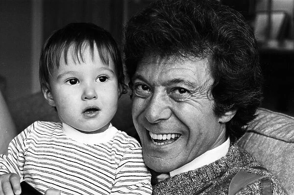 Lionel Blair pictured at home with his son. 19th October 1983