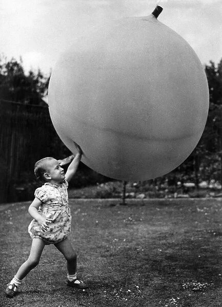 Little boy. big ball With very little effort I can hold up this ball