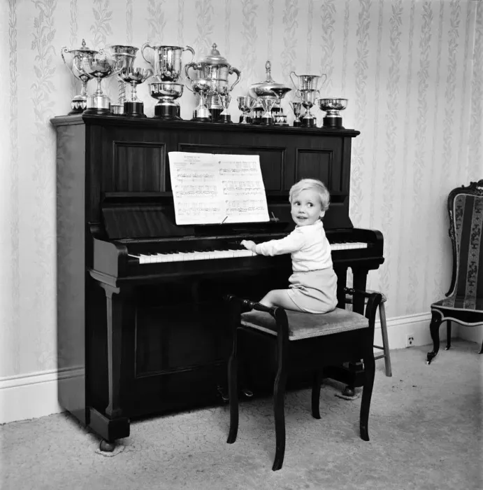 Framed Print : A little boy playing the piano at his home. November 1969 Z10653-001