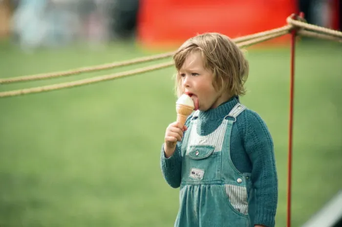Framed Print : A little girl enjoys an ice-cream at Kirkleatham Country Fayre. 1st August 1993