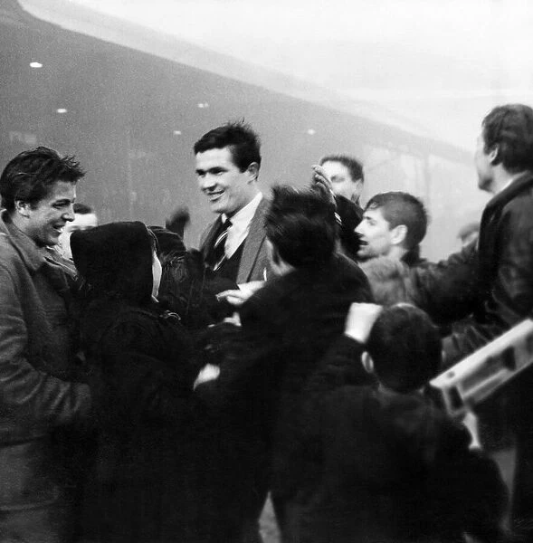 Liverpool captain Ron Yeats is surrounded by worshipping fans who have run on to