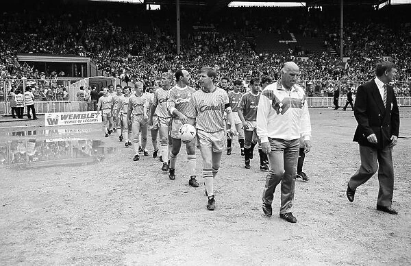 Liverpool coach Ronnie Moran walks out on to the pitch at Wembley as he leads his side