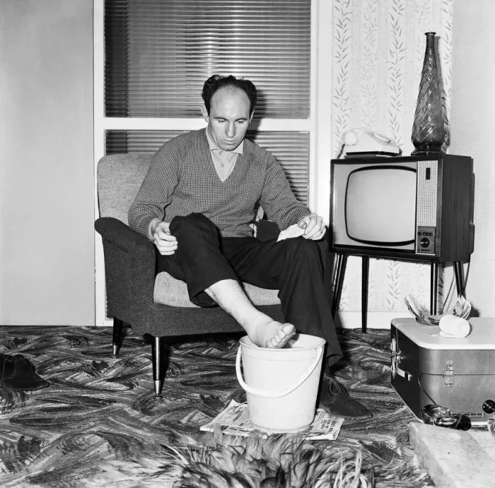 Framed Print : Liverpool and England international footballe Jimmy Melia soothes his injured foot in a Framed Print : Liverpool and England international footballe Jimmy Melia soothes his injured foot in a