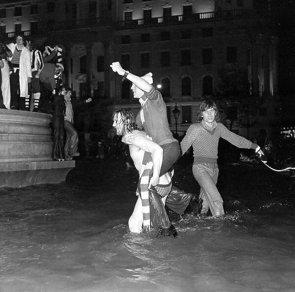 Liverpool fans celebrate their 1974 cup win at Wembley in the fountains of Trafalgar