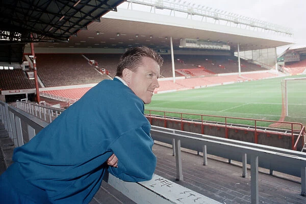 Liverpool football player Steve Nicol poses in the Kop stand at Anfield Stadium