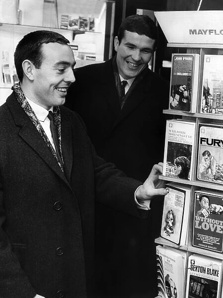 Liverpool football players Ian St. John and Ron Yeats at a bookstall waiting to fly to