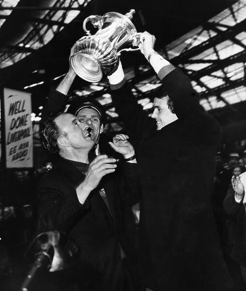 Liverpool football team parade the FA Cup trophy as they arrive back at Lime Street