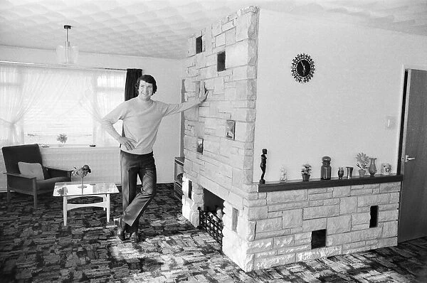 Liverpool footballer Chris Lawler poses at his home in Knowsley near Liverpool