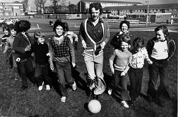 Liverpool footballer David Fairclough finds time for a kick about with some of