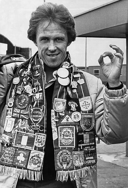 Liverpool footballer Phil Neal wearing a club scarf decorated with badges celebrating