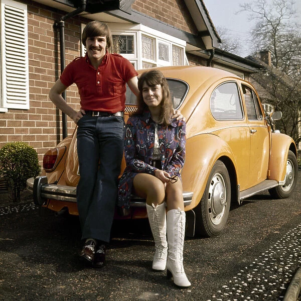 Liverpool footballer Steve Heighway and his wife Sue stand beside their Volkswagen Beetle