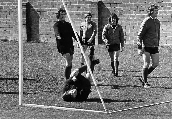 Liverpool footballer Tommy Smith down on the ground after taking a tumble during a light