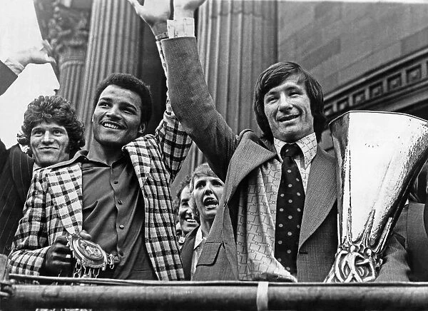 Liverpool footballer Tommy Smith holds the UEFA Cup trophy on an open top bus parade