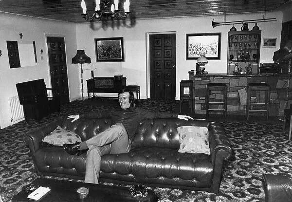 Liverpool footballer Tommy Smith at home on his sofa. 19th December 1973