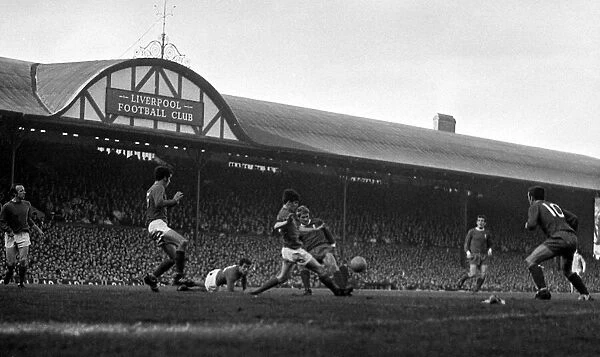 Liverpool forward Ron Yeats challenged for the ball by Manchester United defenders during