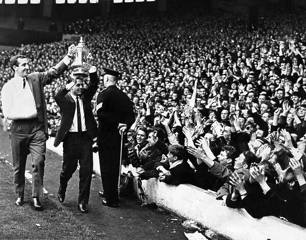 Liverpool injured footballers Gerry Byrne and Gordon Milne parade the FA Cup trophy to