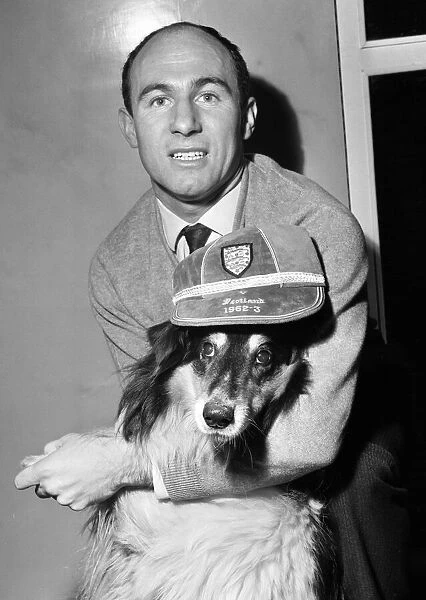 Liverpool inside forward Jimmy Melia celebrates with pet collie dog Sheena at his