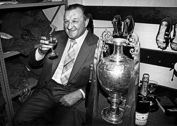 Liverpool manager Bob Paisley celebrates with a glass of champagne in the boot room at