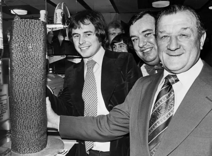 Framed Print : Liverpool manager Bob Paisley helps Nick Owen of BBC radio Birmingham transfer a pile of