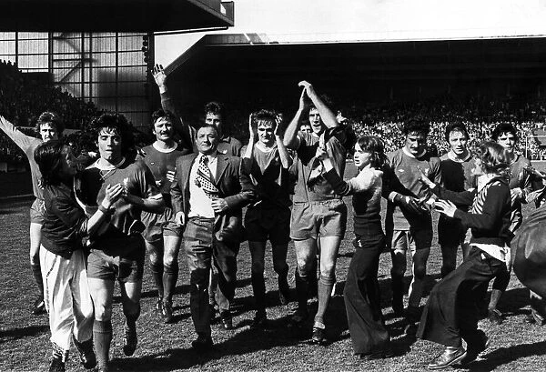 Liverpool manager Bob Paisley leads his team on a lap of honour to salute the Kop