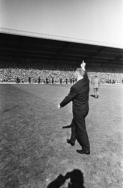 Liverpool manager Bill Shankly acknowledges the cheers of the crowd as they celebrate