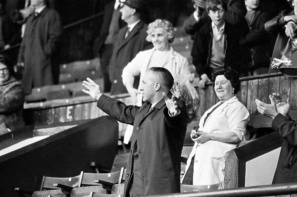Liverpool manager Bill Shankly acknowledges the cheers of the Kop ahead of his side