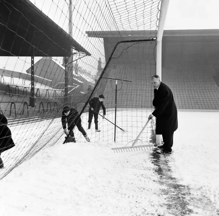 Framed Print : Liverpool manager Bill Shankly helps to clear the snow from the goal line on the Anfield Framed Print : Liverpool manager Bill Shankly helps to clear the snow from the goal line on the Anfield