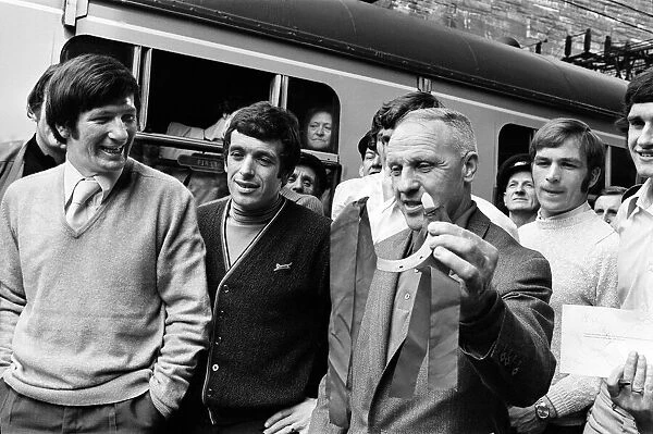 Liverpool manager Bill Shankly pictured with his team, holding a lucky horseshoe at Lime