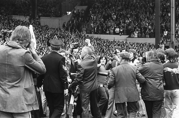 Former Liverpool manager Bill Shankly salutes the Liverpool fans as he walks around