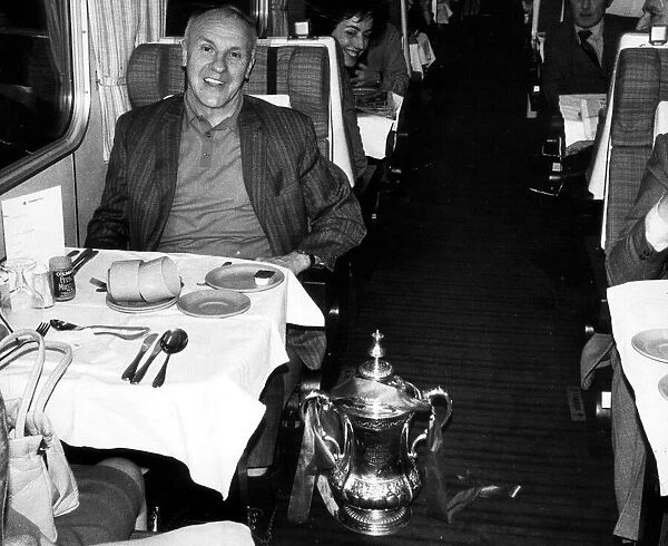 Liverpool manager Bill Shankly sitting at his table on the train home to Liverpool with