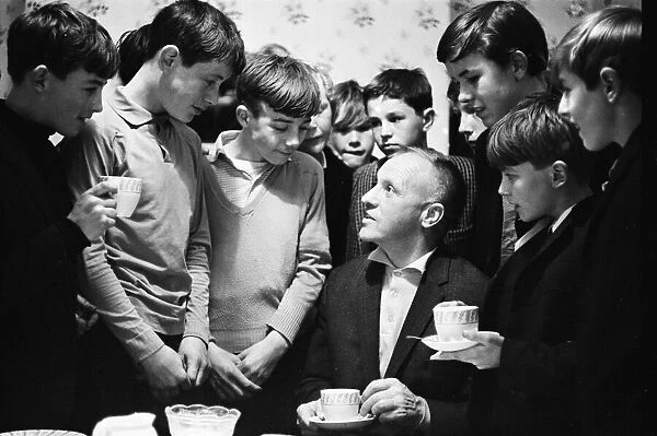 Liverpool mananer Bill Shankly watches a game of Street football from a flat above Eldon