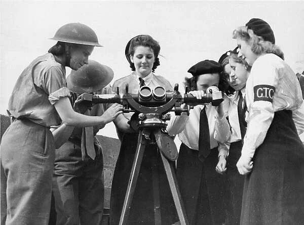 Liverpool members of the Girls Training Corps displaying a keen interest in an instrument