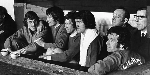 Liverpool players on the bench watching as Bill Shankly takes the field in the half time