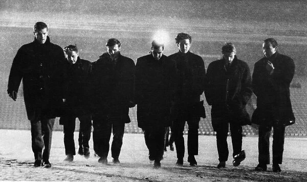 Liverpool players inspect the pitch at Anfield before a match was due to start