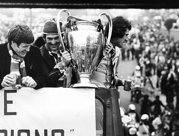 Liverpool players proudly show off the European Cup trophy to thousands of fans who lined