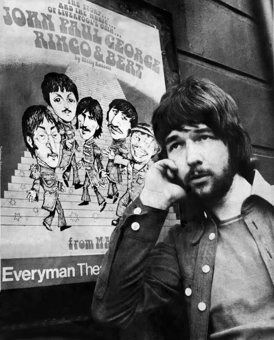 Framed Print : Liverpool playwright Willy Russell poses besides a poster for his play John, Paul, George