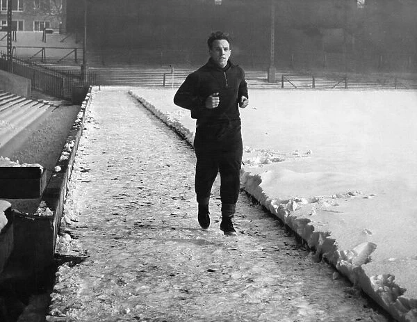 Liverpool full back Ronnie Moran putting in a spot of training despite conditions at