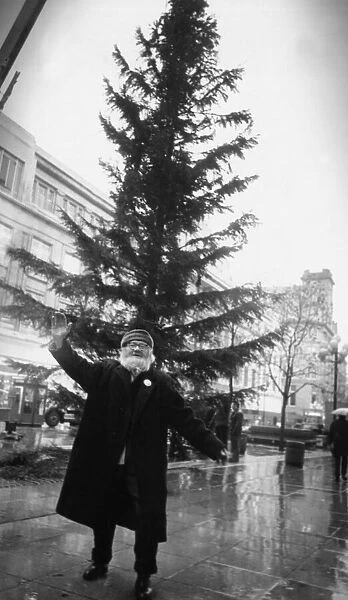 Liverpool Street musician Augustus Broll does a jig around the Christmas tree in Church